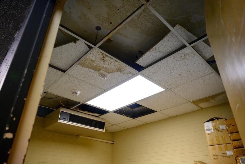 A decaying ceiling and leaking air conditioner are seen in a room used for storage at Bonham Middle School Wednesday, Sept. 13, 2023 in Odessa. The school, which was built in 1954, is now seeing advanced signs of aging such as a leaking roof, decaying infrastructure and foundational cracking.
