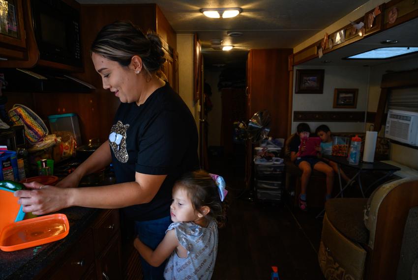Alexa Miranda, 4, hugs her mother, Maria, as she cleans dishes in their travel trailer Thursday, Sept. 14, 2023 in West Odessa. Maria, a native of Chicago, moved her family to West Odessa after her husband got a job as a driver in the oilfields.