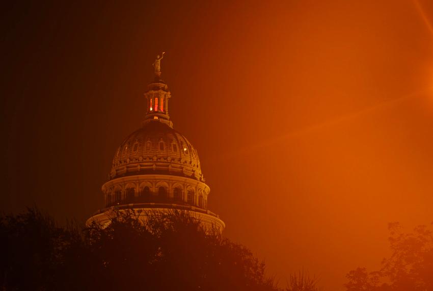 Streetlights illuminate the Texas Capitol through early morning fog on the ninth day of suspended Attorney General Ken Paxton’s impeachment trial in Austin on Sept. 15, 2023.