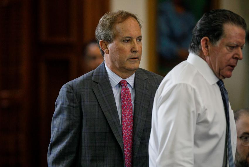 Texas Attorney General Ken Paxton, center, walks back to his seat after speaking privately with defense attorney Dan Cogdell before starting the ninth day of his impeachment trial in the Senate Chamber at the Texas Capitol on Friday, Sept. 15, 2023, in Austin.