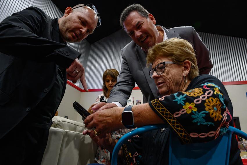 Ector County Independent School District teacher and political consultant Arlo Chavira, far left, ECISD Superintendent Scott Muri, second from right, and ECISD School Board Trustee Tammy Hawkins, far right, read election results during an election night watch party Tuesday, Nov. 7, 2023, in Odessa.