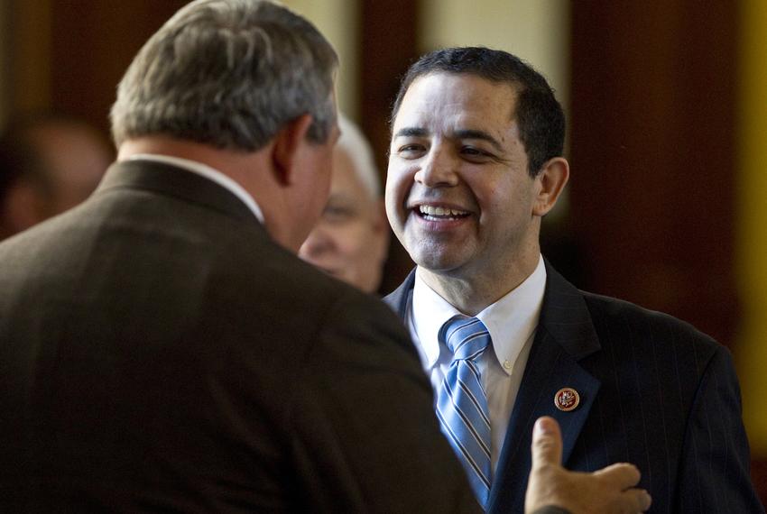 U.S. Rep. Henry Cuellar (D-Laredo) speaks with state Rep. Doug Miller R-New Braunfels, during a visit to the Texas Capitol on Feb. 19, 2013.