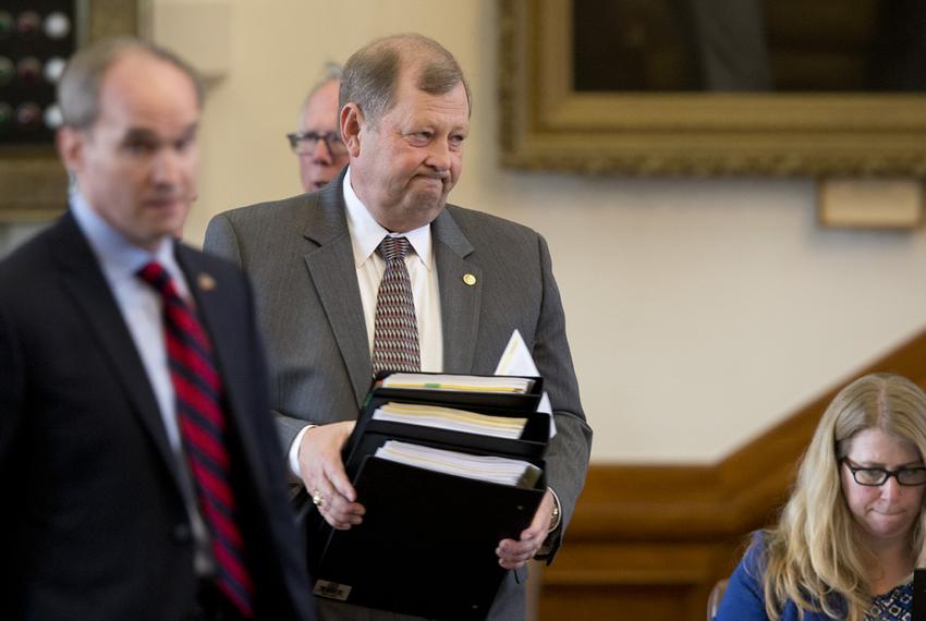 State Rep. John Otto, R-Dayton, carries literature laying out House Bill 1 as he prepares to discuss the appropriations bill on the House floor March 31, 2015.