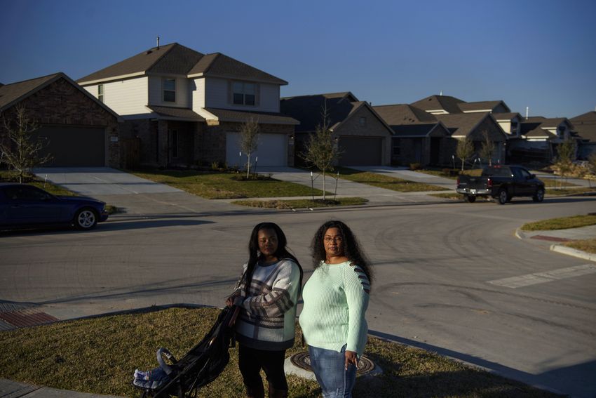 Teressa Tolon, 24, and her mother, Nakisha Platt, 47, take a walk through the neighborhood where Platt recently purchased a home with the help of the Community Land Trust, a nonprofit organization that aims to make homeownership affordable for low-income households, in Porter, Texas, U.S., on Friday, January 13, 2023. Despite its goal of creating more than 1,000 permanently affordable homes in five years, the Community Land Trust has only 100 homes in its trust and the city of Houston may cut its funding significantly.