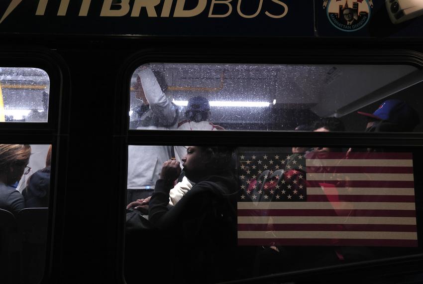 Asylum seekers are transferred via city bus from the Port Authority bus terminal to a housing facility on May 14, 2023, in New York City, New York.