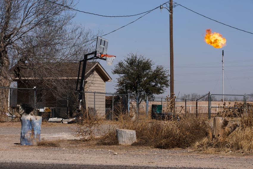 A natural gas flare operates less than 200 yards away from a family home on March 14, 2022 in Midland.