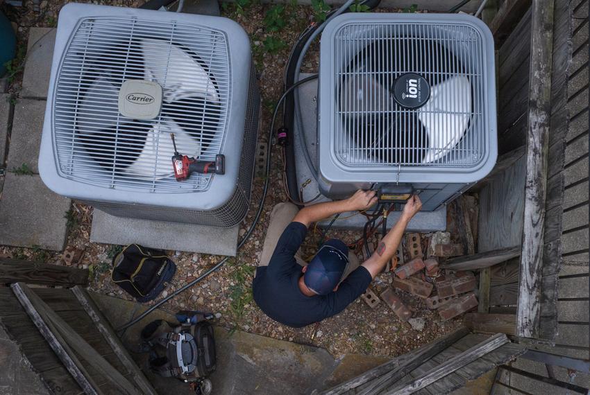 Geoff Bell, a HVAC technician with Texas Pride Air Conditioning and Heating, tests the refrigerant levels in an air conditioning unit during a heat wave Thursday, Aug. 24, 2023 in Houston.