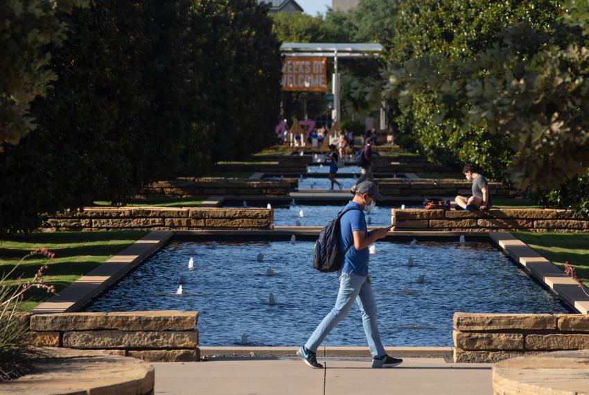 Students walk through campus at the University of Texas at Dallas on Aug. 27, 2021.